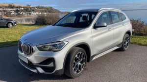 BMWX1 car sitting at harbour